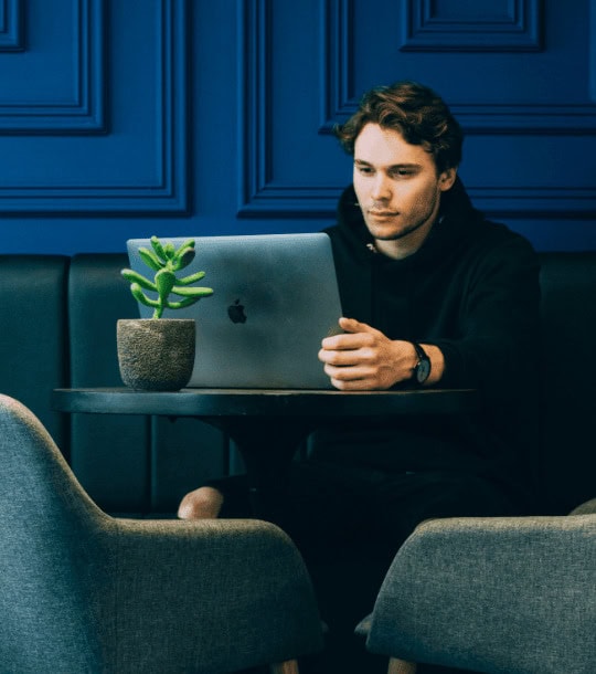 A man using a laptop to seel his home
